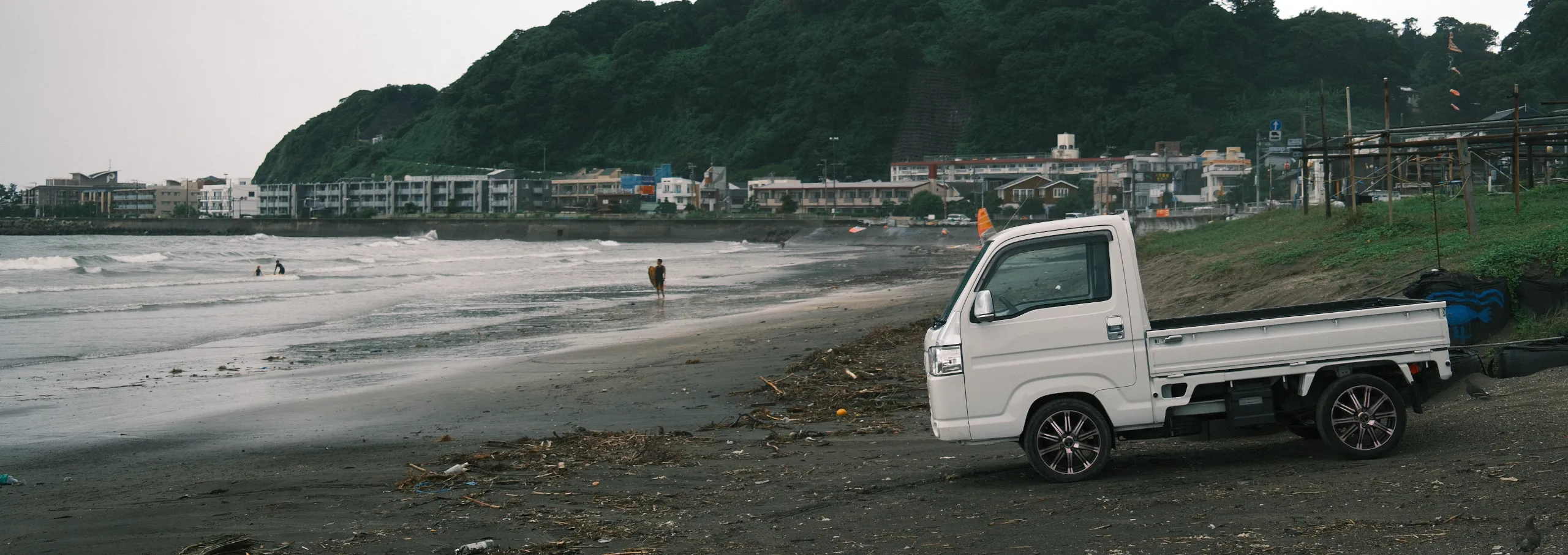 A Japanese Kei Truck driving down the road